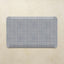 Rectangular placemat with blue grid pattern on a beige background