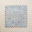 Blue patterned foam puzzle mat on a beige background
