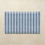 Rectangular mat with blue and gray striped pattern on a beige background