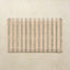 Rectangular kitchen mat with striped pattern on a beige background