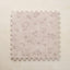 Floral patterned foam puzzle mat on a beige background