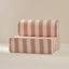 Striped pink and brown sofa on a beige background