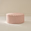 Striped ottoman on a beige background