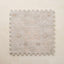Patterned neutral play mat tile on a beige background