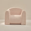 Pink textured armchair on a neutral background