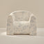 Floral-patterned armchair on a beige background