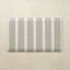 Rectangular kitchen mat with black vertical stripes on a beige background