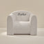 White play chair with 'Parker' embroidery on a beige background