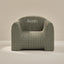 Green checkered armchair with 'Kevin' embroidered on a beige background