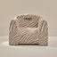 Zebra-patterned chair with 'Hugo' embroidery on a beige background