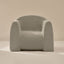 Light gray textured armchair on a beige background