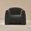 Dark gray boucle armchair on a beige background
