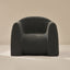Dark gray boucle armchair on a beige background