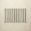Striped bath rug with green and beige stripes on a beige background