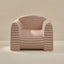 Striped armchair with pink and beige stripes on a neutral background