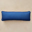 A rectangular lumbar pillow with a blue and black checkered pattern, displayed against a neutral beige background.