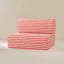 A red and white striped seat, set against a plain beige studio background.