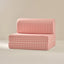 Pink checkered sofa on a beige background