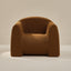 Brown boucle armchair on a neutral background
