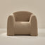 Beige boucle armchair on a neutral background
