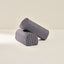 Two cylindrical armrests with striped pattern on a beige background