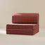 Striped sofa bed with red and brown stripes on a beige background