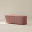 Pink striped ottoman on a beige background