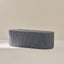 Blue striped ottoman on a beige background