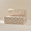 Beige and black patterned play seat on a beige background