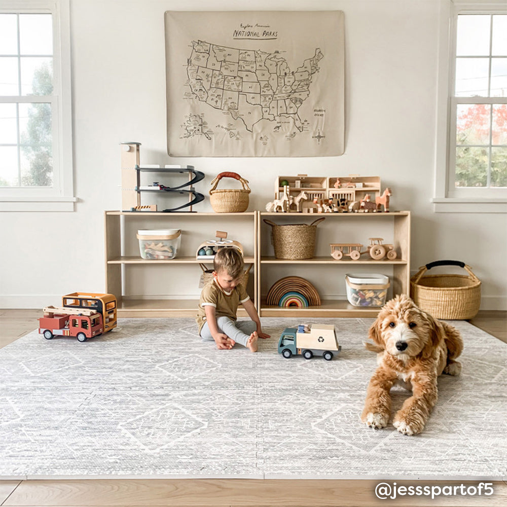 Gray boho print baby play mat shown in play room with baby boy playing with toys with his dog. @jesspartof5 written in bottom right hand corner.