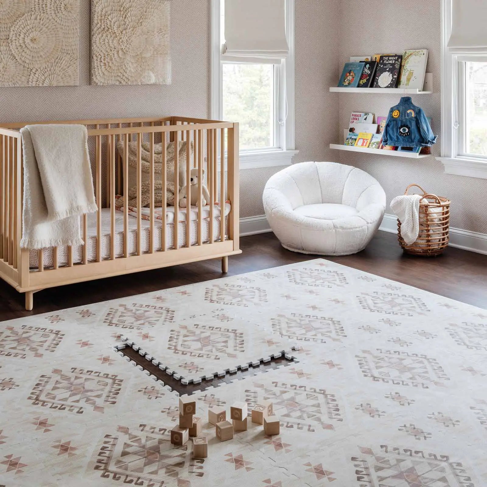 Nalla Mojave neutral beige brown and pink boho print play mat shown in nursery with one tile exposed and wooden blocks on the mat