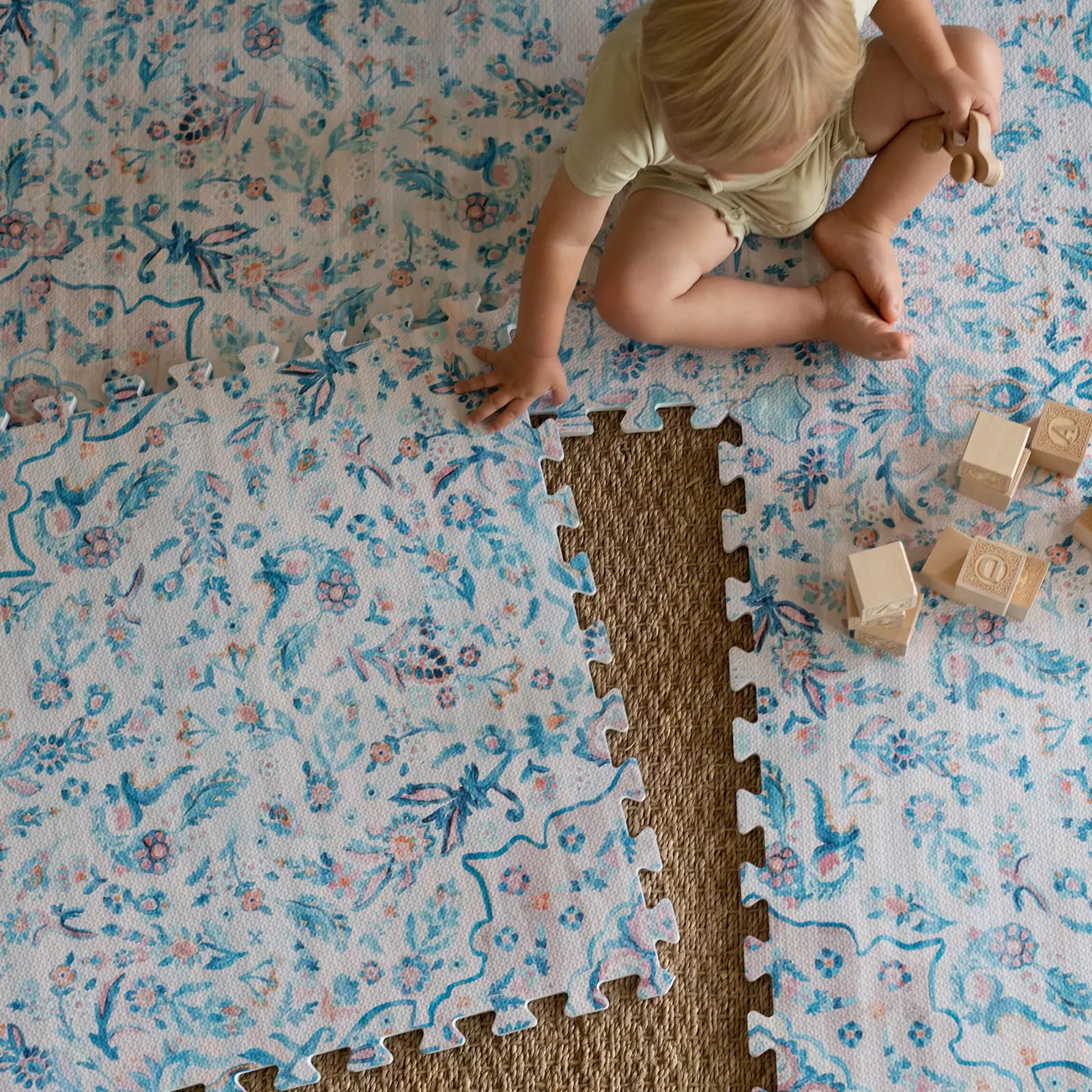 Emile Pale Aqua Blush Floral Boho Baby Play Mat with baby playing with blocks