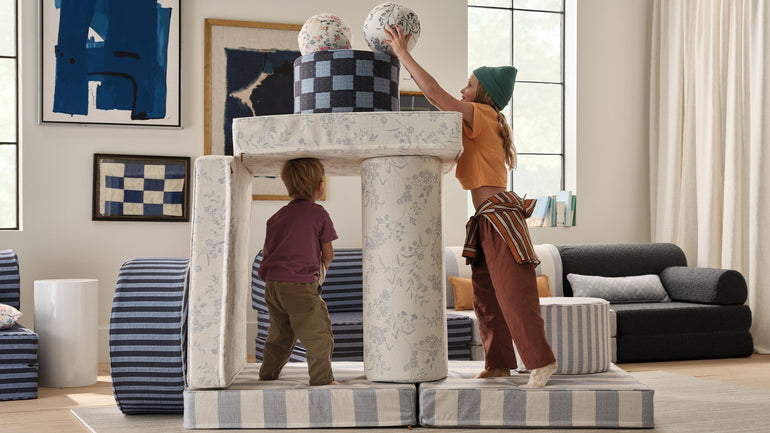 two kids using play furniture in their play room
