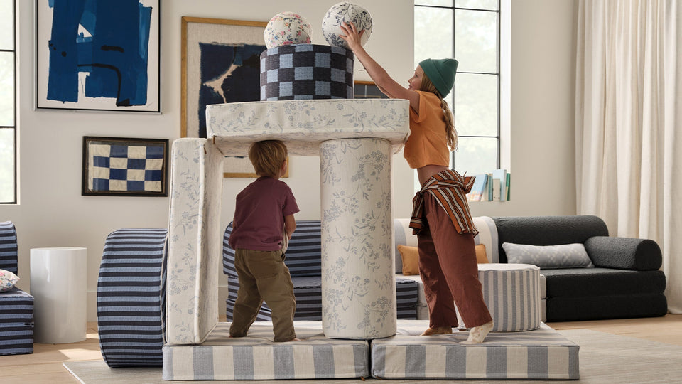 two kids using play furniture in their play room