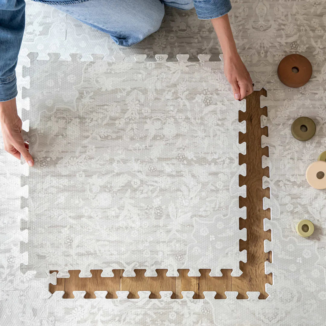 woman placing down eva foam play mat 