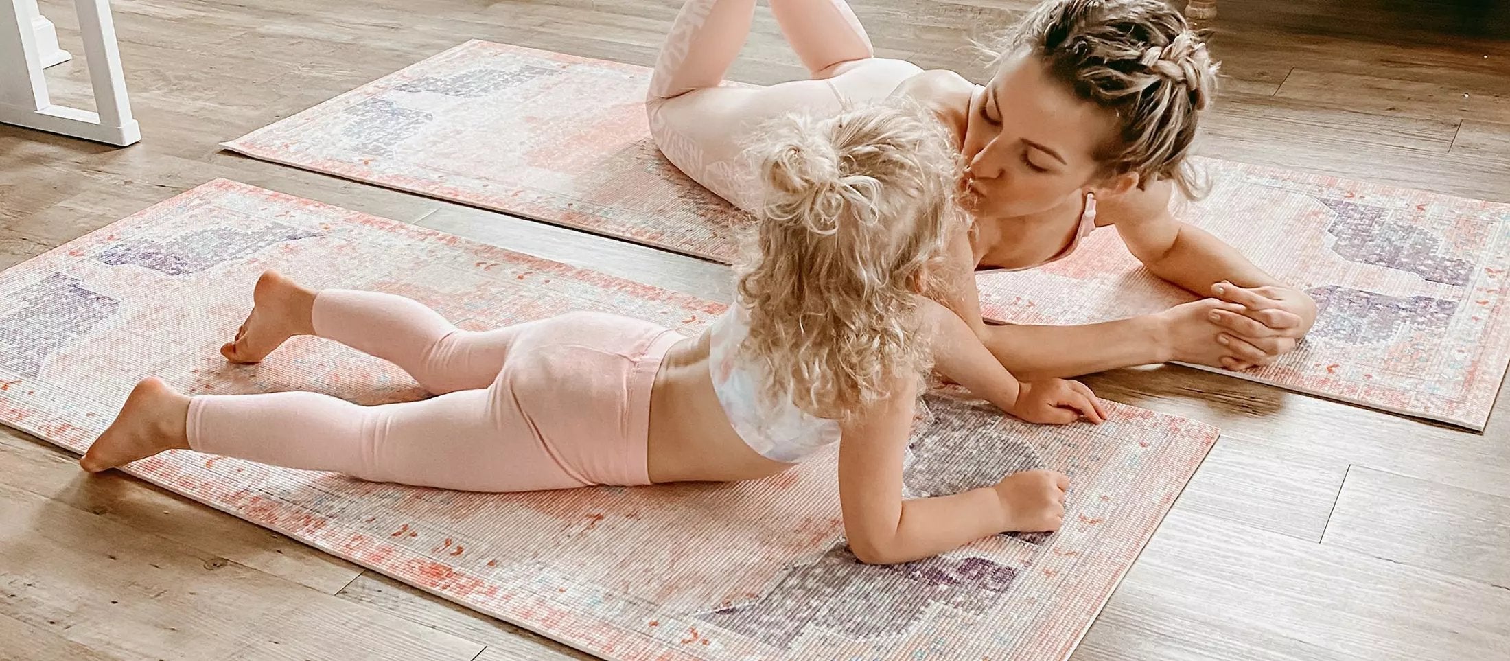 mom and little girl doing yoga on Eden pink Persian yoga mats