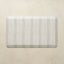 Rectangular kitchen mat with a striped pattern on a beige background