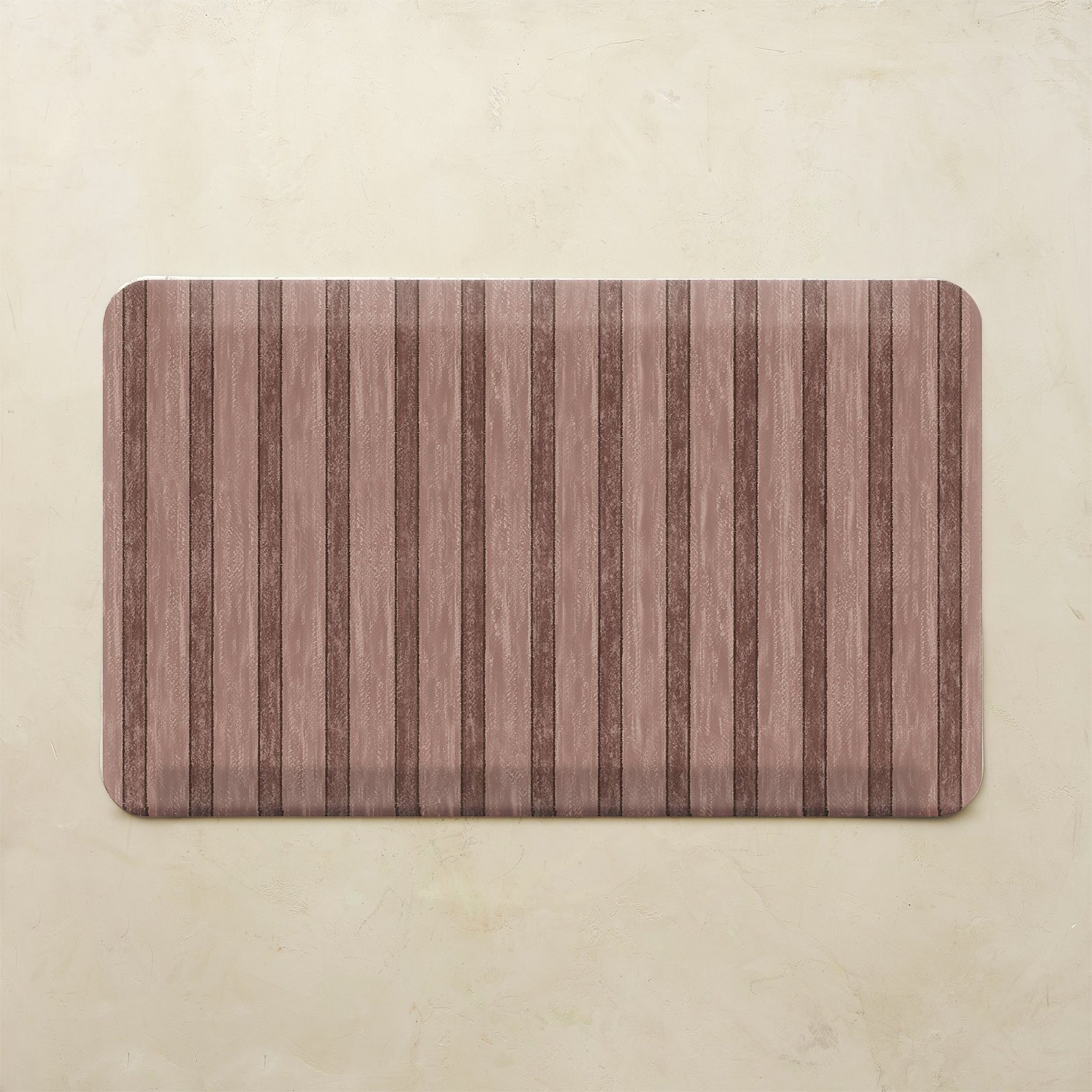Maroon kitchen mat with striped pattern on a beige background