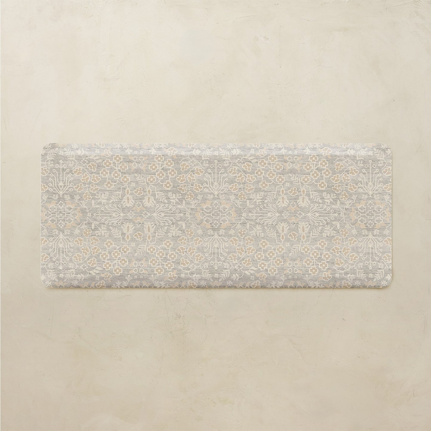 Floral patterned kitchen mat on a beige background