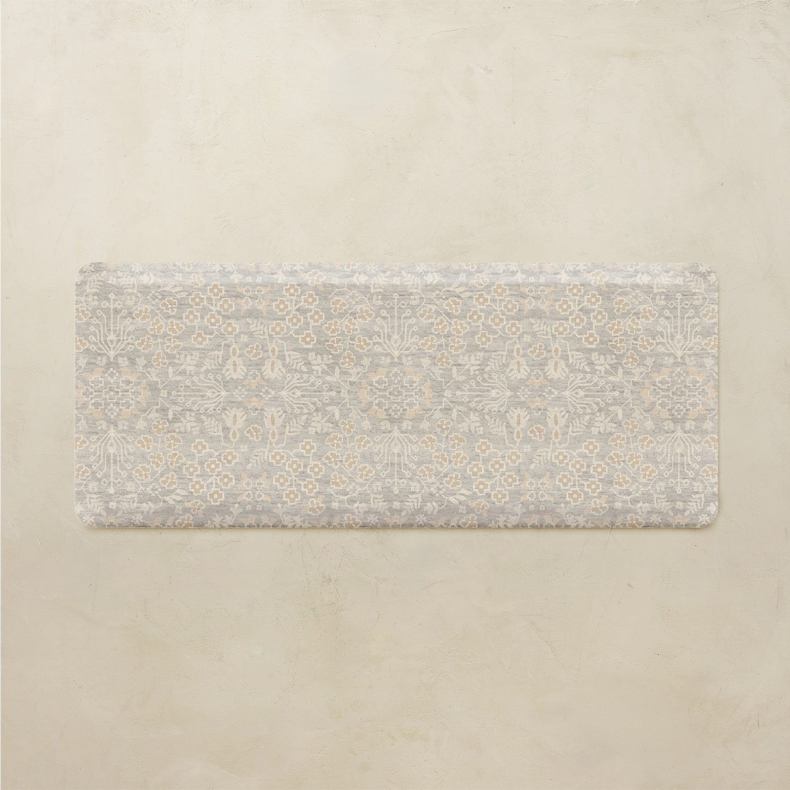 Floral patterned kitchen mat on a beige background