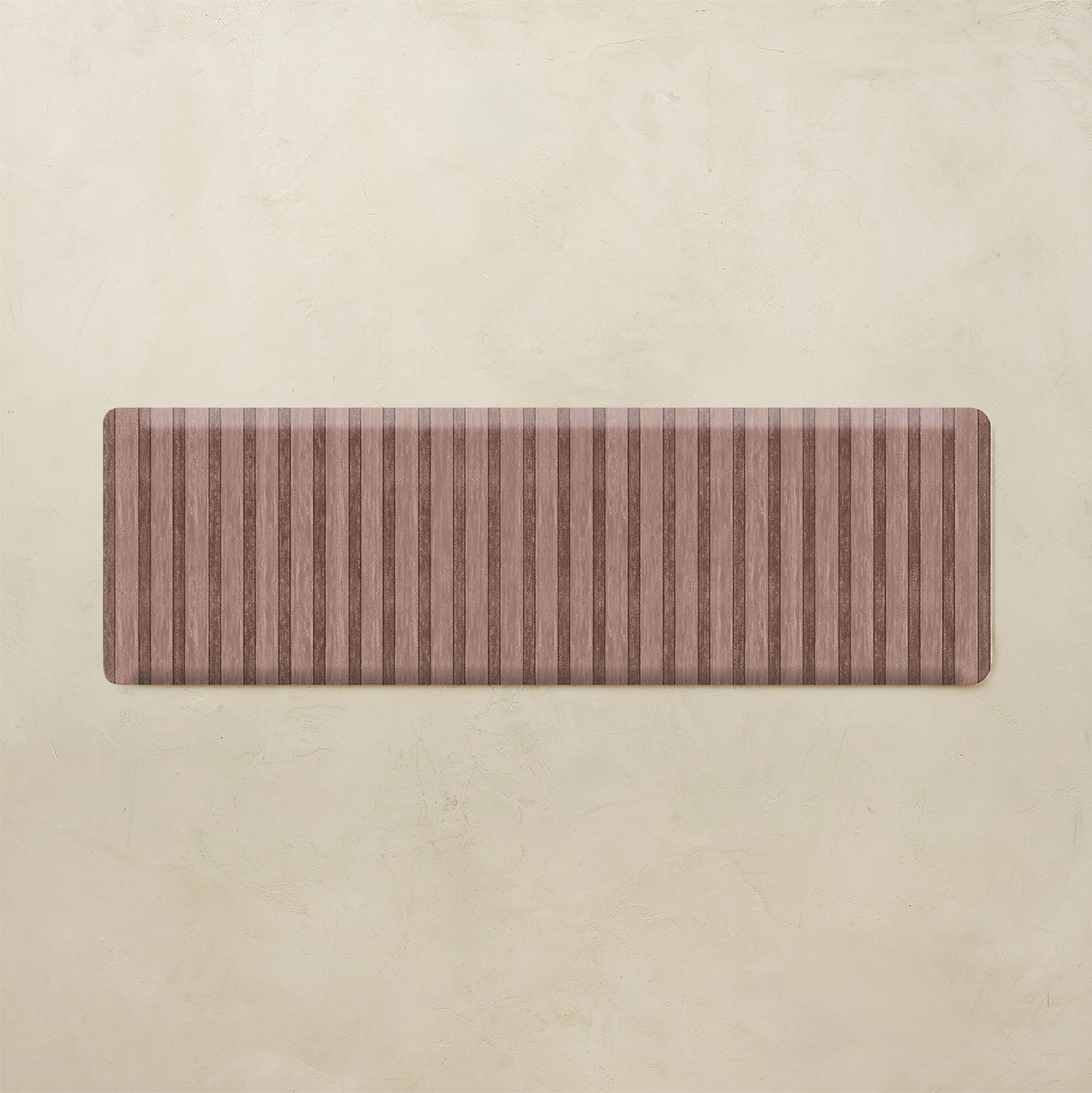 Maroon kitchen mat with striped pattern on a beige background