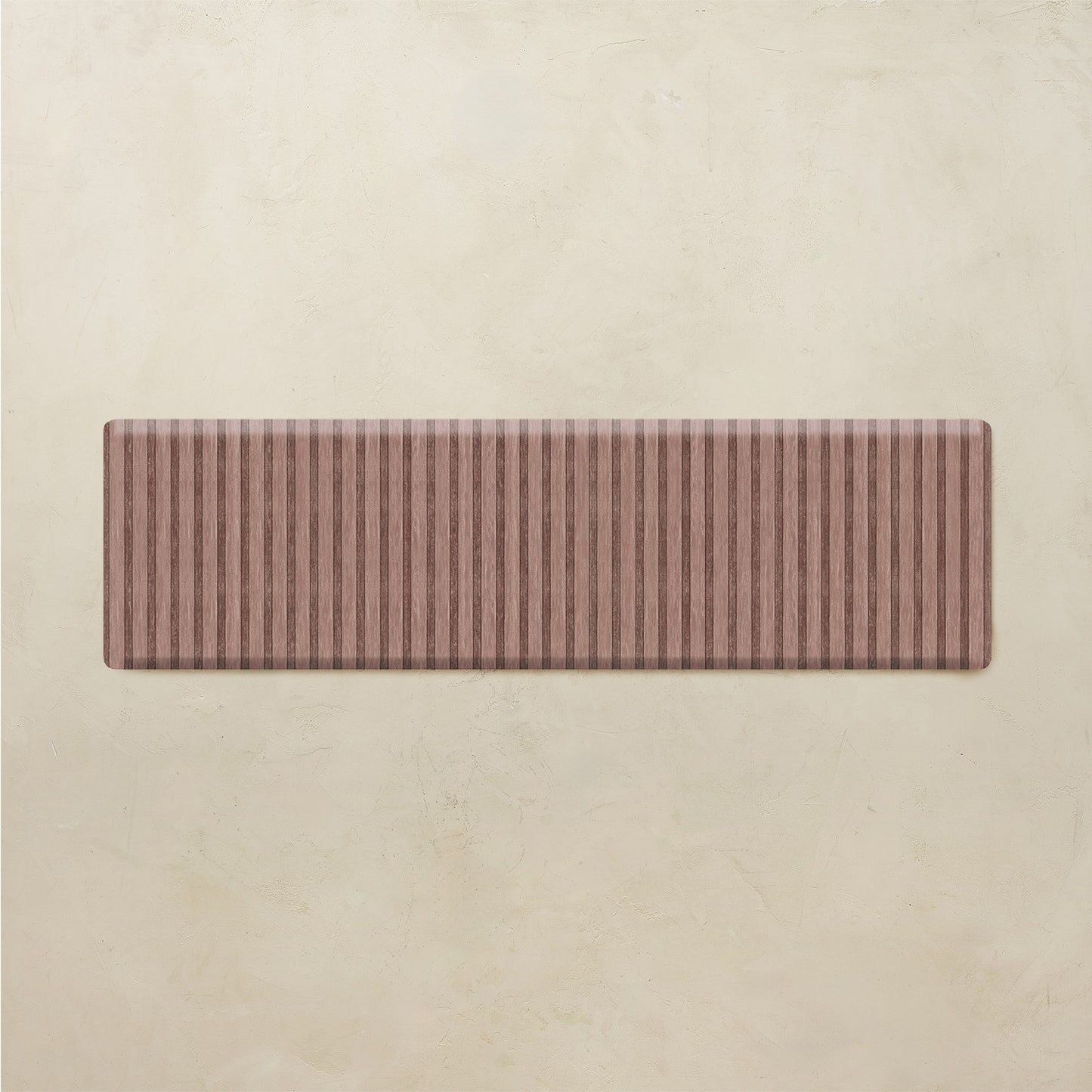 Maroon kitchen mat with striped pattern on a beige background