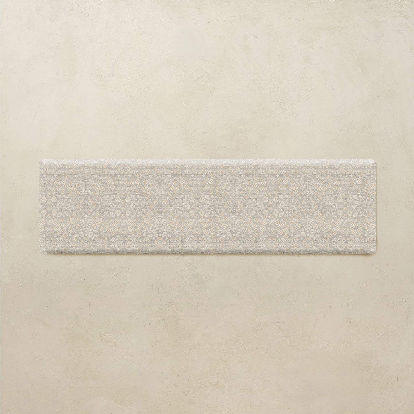 Rectangular floral mat on a beige background