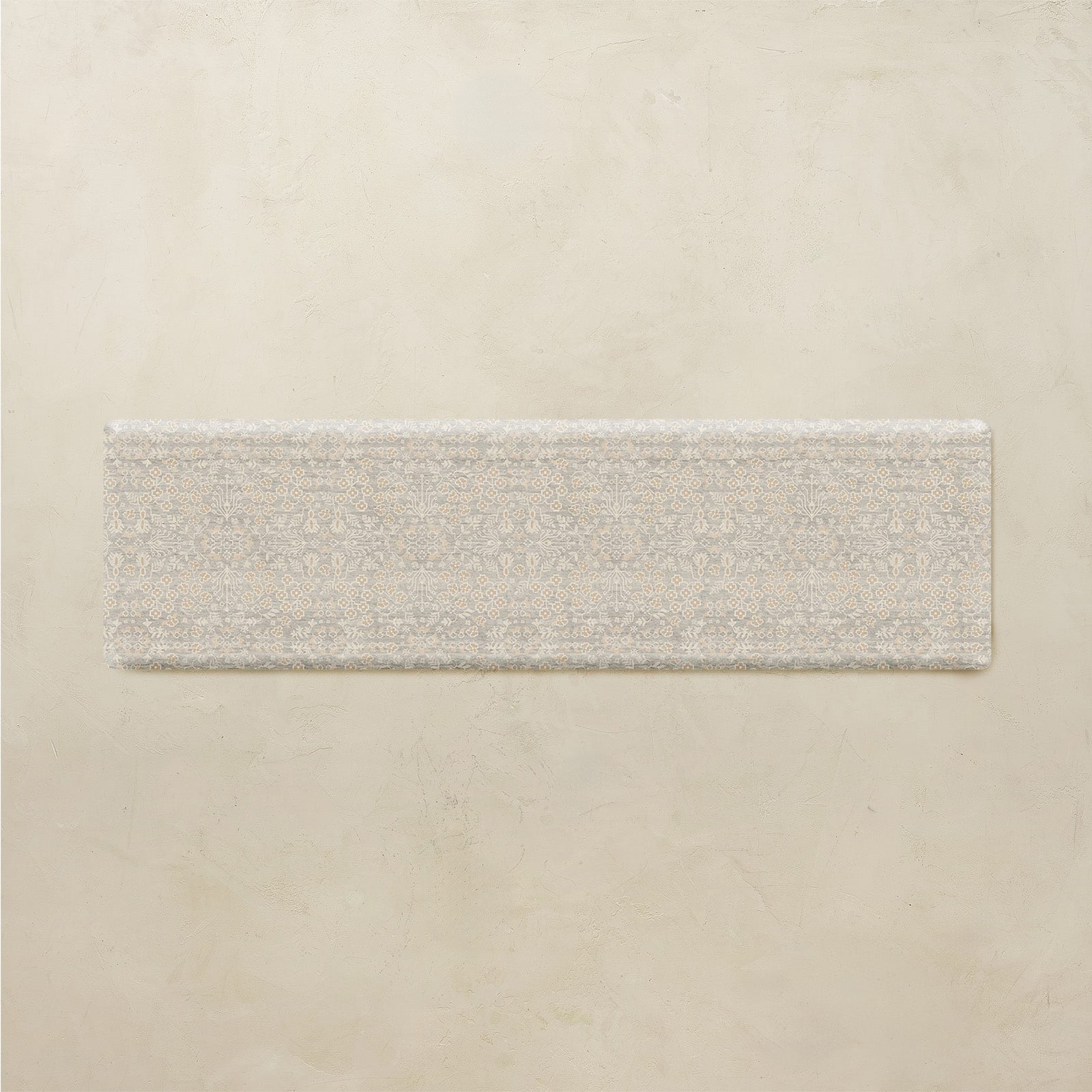Rectangular floral mat on a beige background