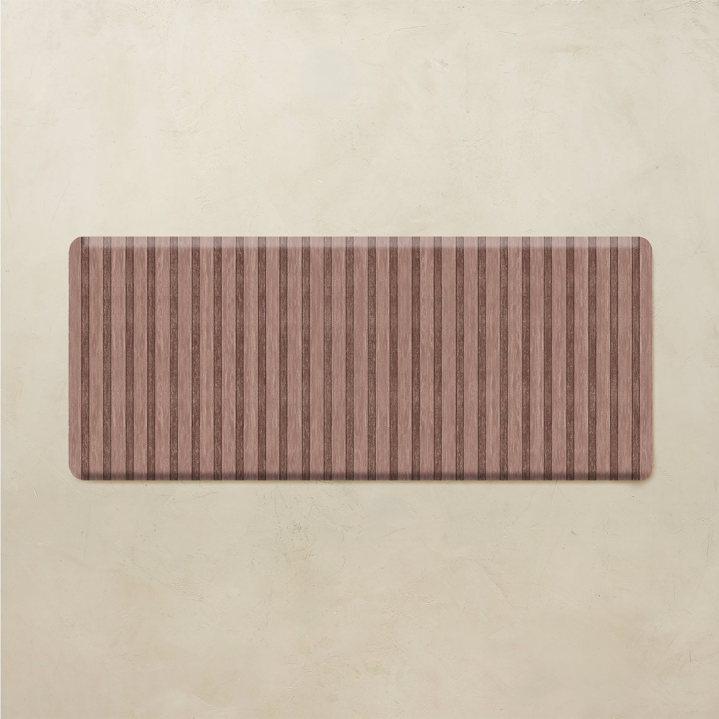 Rectangular brown striped kitchen rug on a beige background