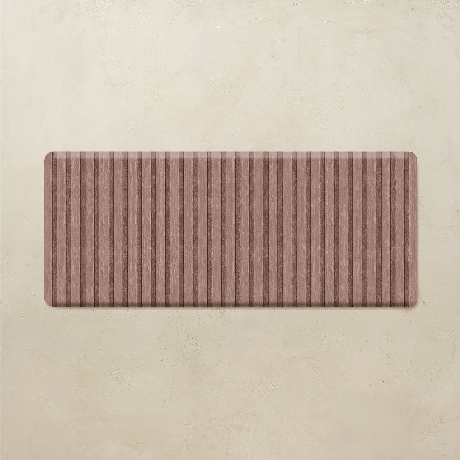 Rectangular brown striped kitchen rug on a beige background