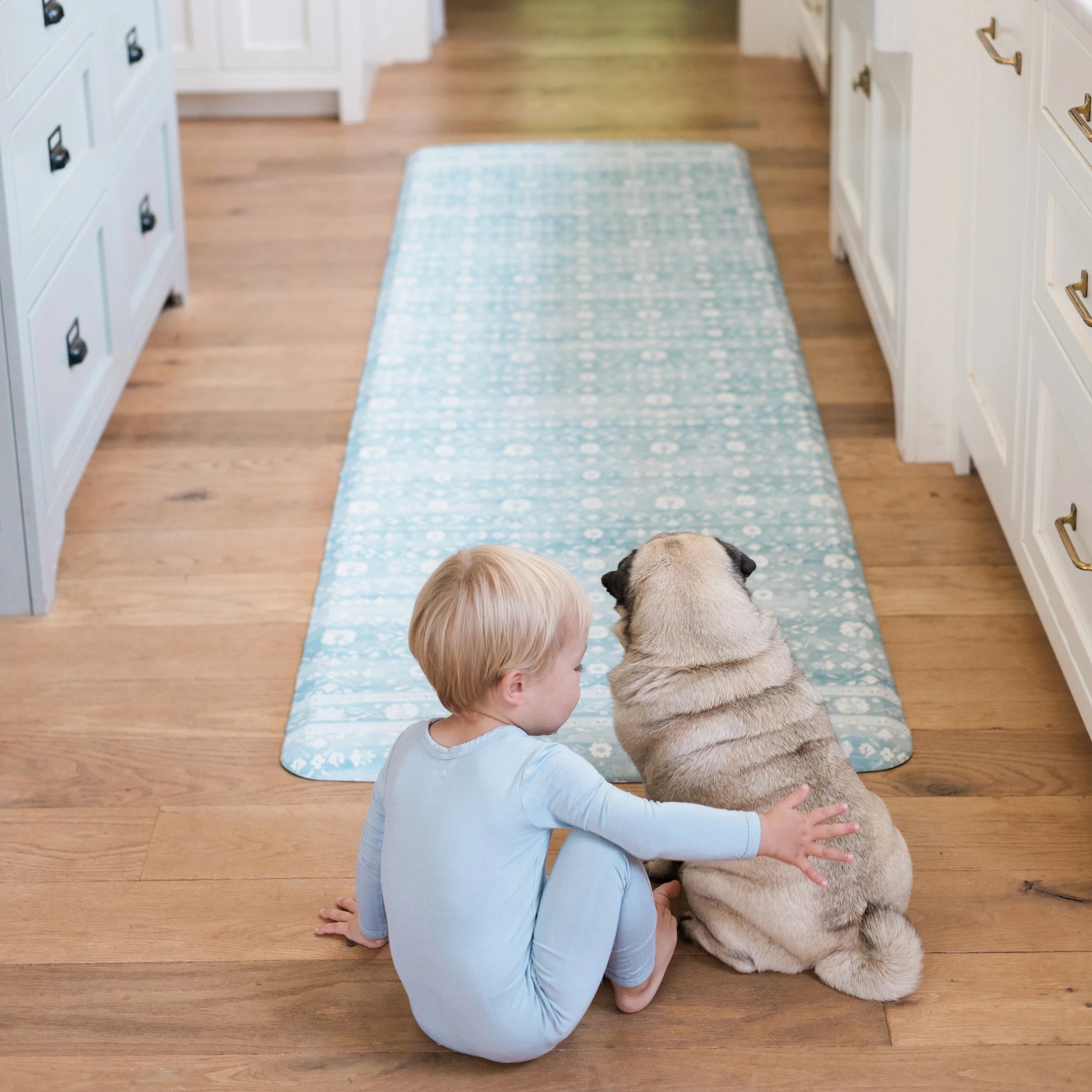 Nama standing mat Gemma White Sage green in kitchen with baby and dog shown in size 30x108