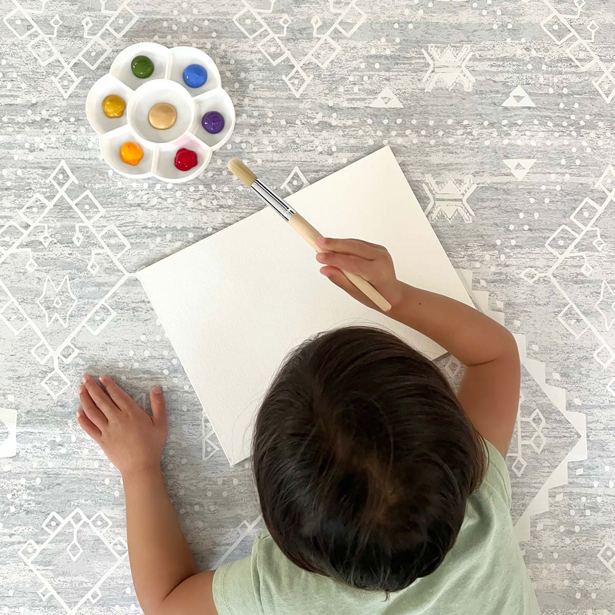 Ula gray boho splat mat shown from above with baby painting