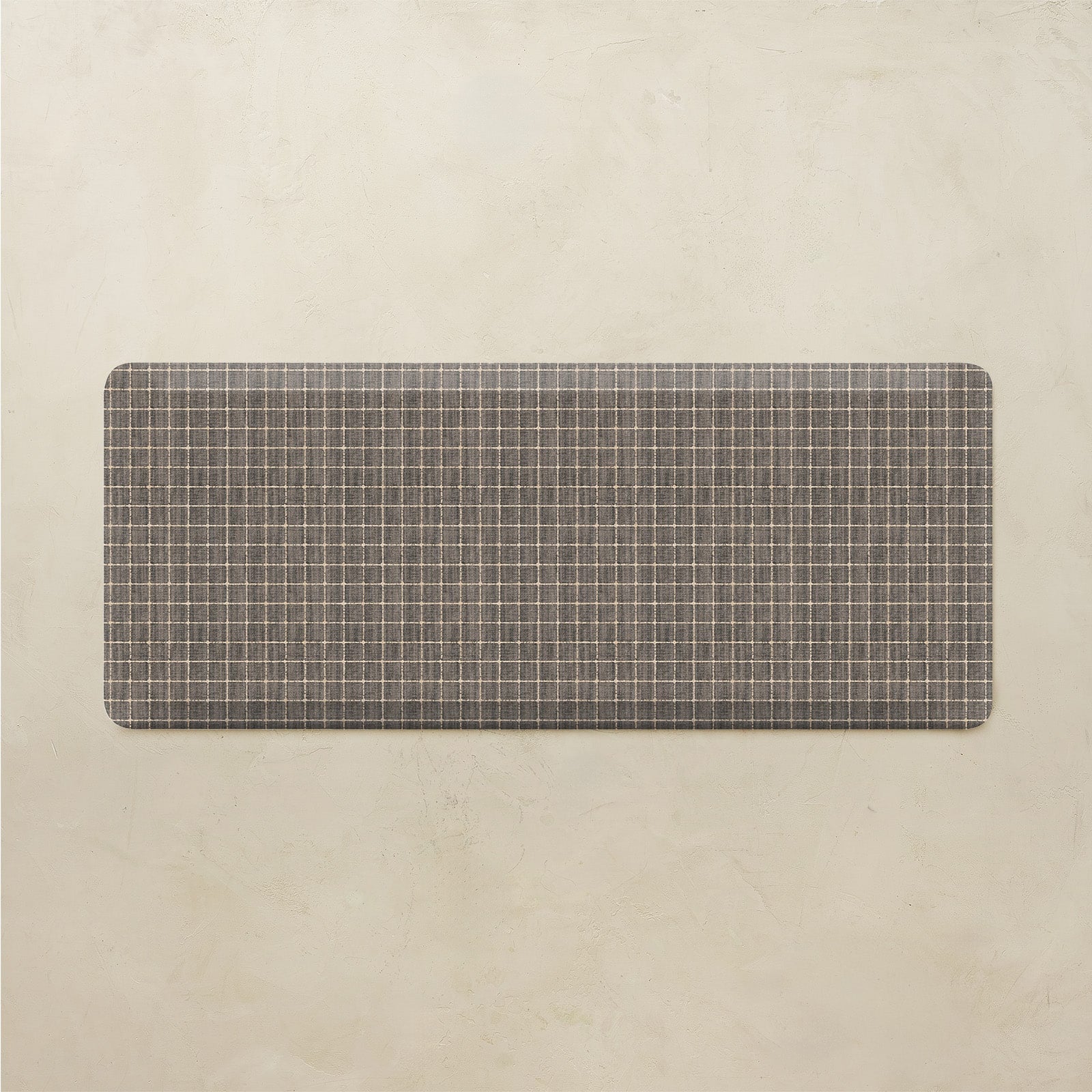 Rectangular grid pattern kitchen mat on a beige background