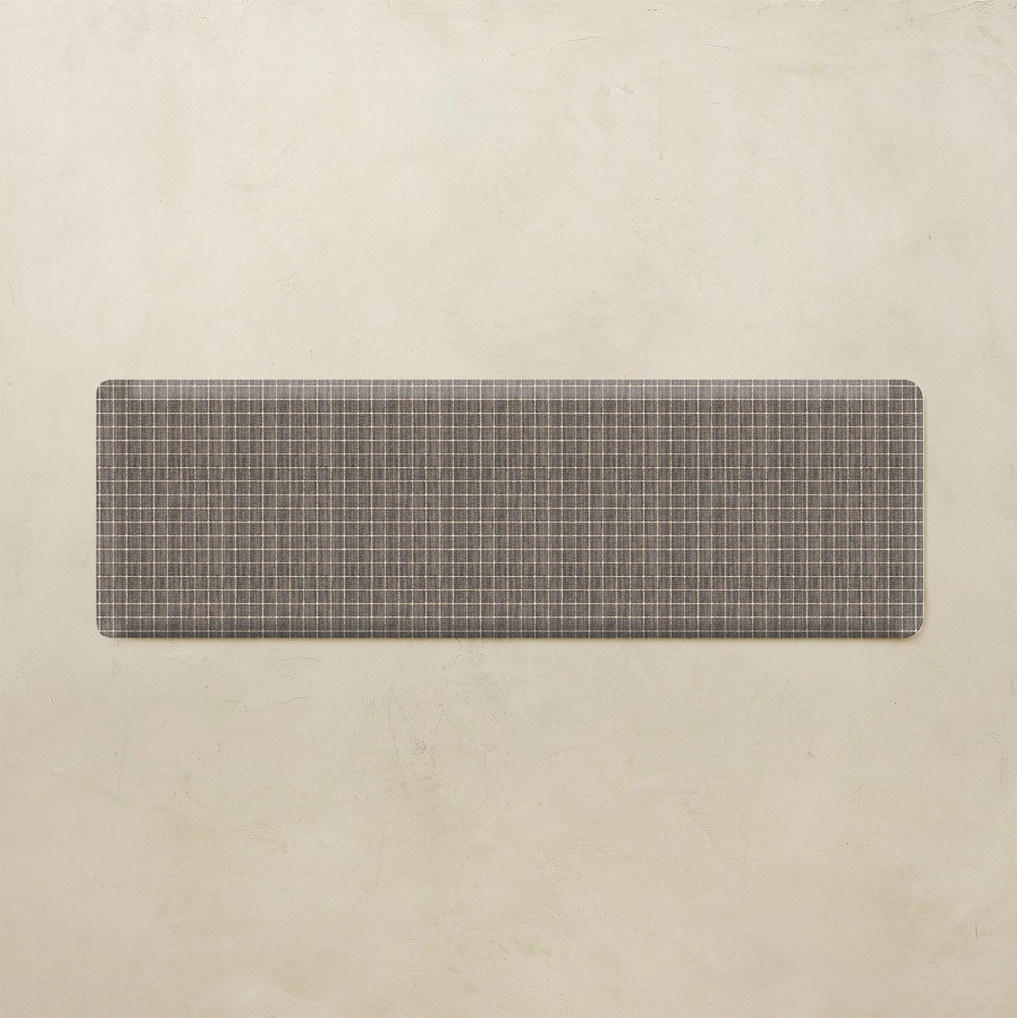 Rectangular mat with grid pattern on a beige background